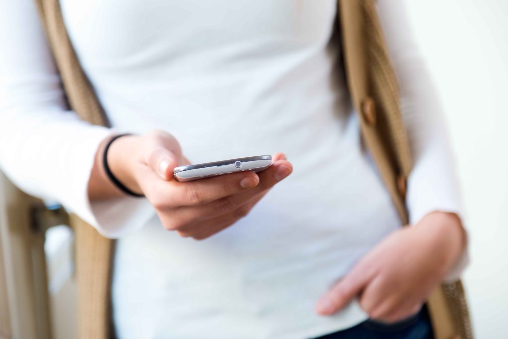 beautiful-young-woman-using-her-mobile-phone-home-11zon-etH4ktbpzKGKfzHqlB6w