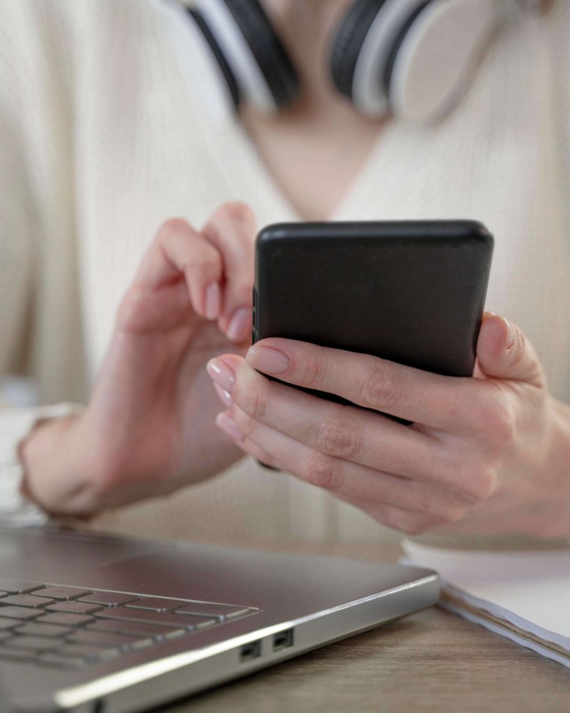 close-up-woman-using-smartphone-laptop-1-fmiEtOu13BTGkpUpbO3s